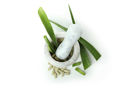 Concept of herb pills with aloe isolated on white background, a Beauty & Fashion Photo by AtlasStudio PRO