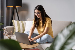 Young woman with glasses leans into, a Person Photo by AD Stock Images