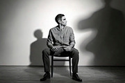 Person sitting alone on a chair with in an empty room at backgro, a Health & Medical Photo by DanFLCreativo (Thumbnail 2 of 2)