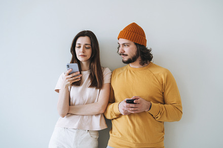 Young couple with mobiles, a Person Photo by Galina_Zhigalova