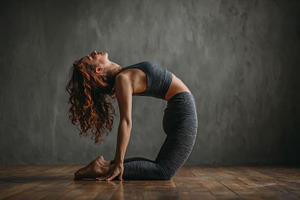 Person practicing camel pose in yoga, a Photo by Beautiful things