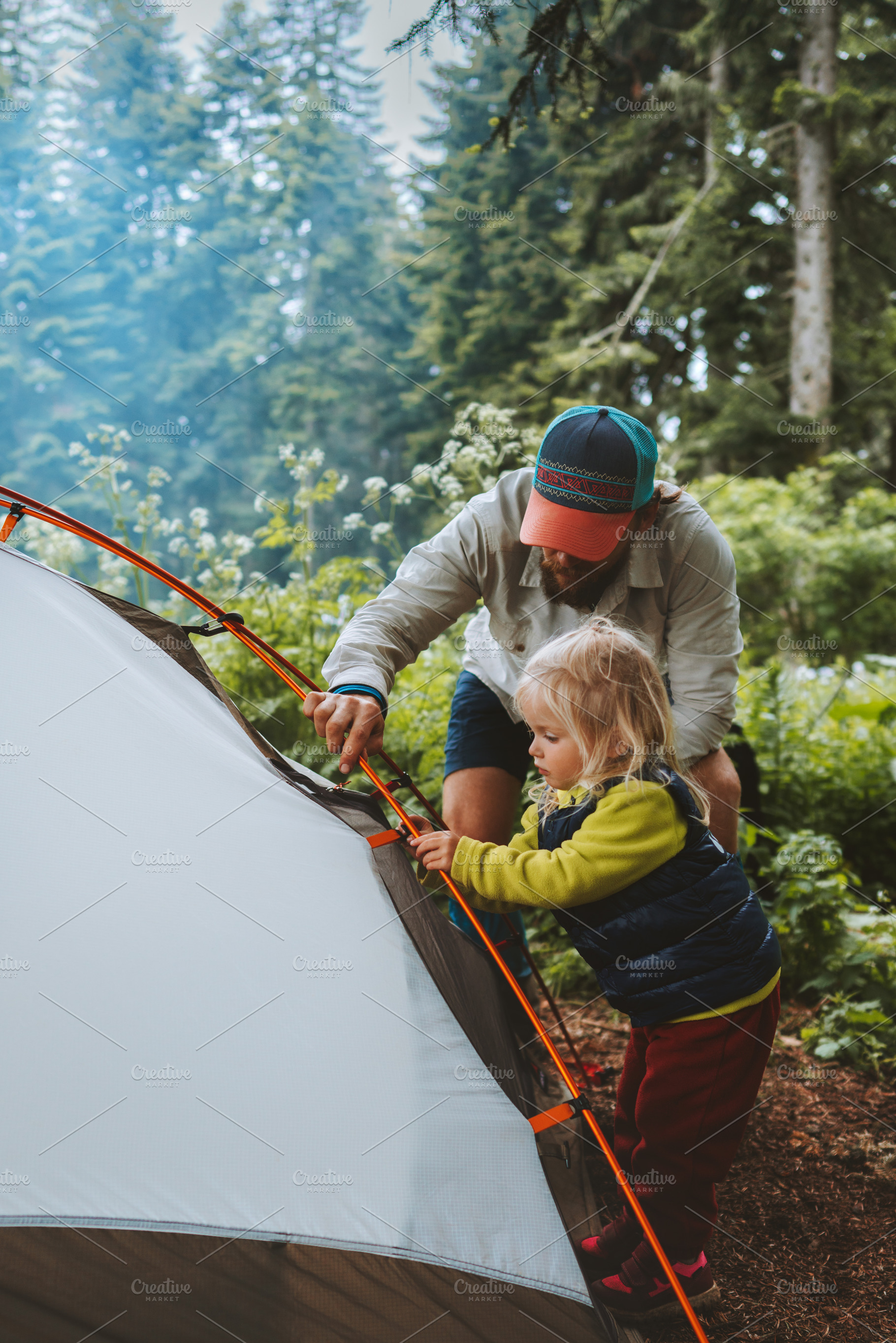 Child helps father to set camping tent travel family vacations hiking outdoor a, a Person Photo by e v e r s t