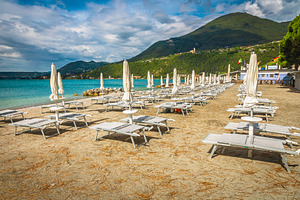 Stunning beach with white parasols, a Sports & Recreation Photo by Alpine Dreams