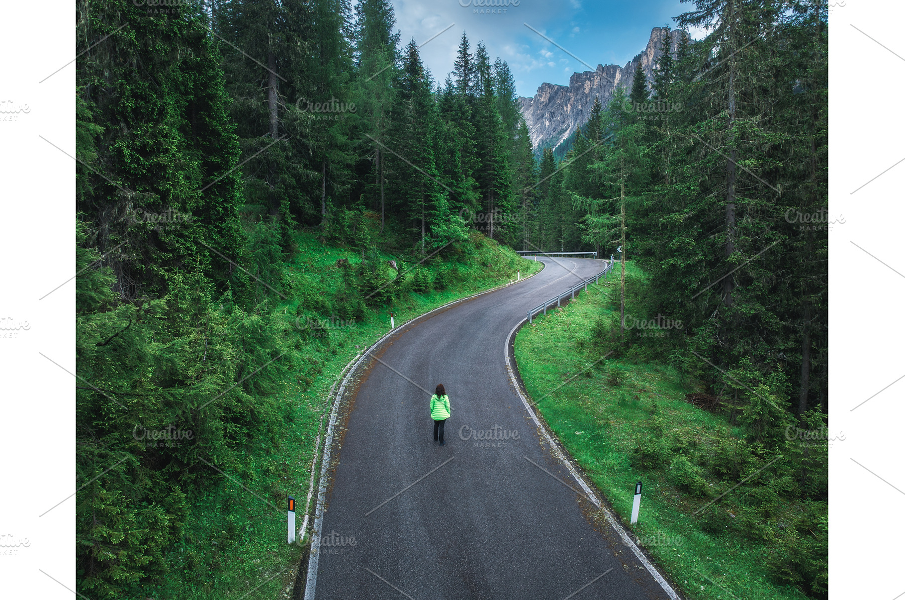 Woman walking on a winding road in, a Transportation Photo by den-belitsky