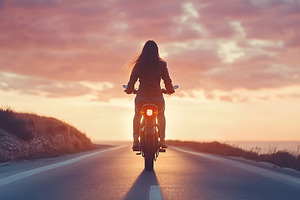 Woman enjoys a scenic ride on an electric bike along the coastal route at sunse, a Sports & Recreation Photo by AlyaAnd