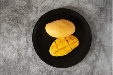 Fresh yellow mango fruit in a black, a Food & Drink Photo by Jan Jack Russo Media