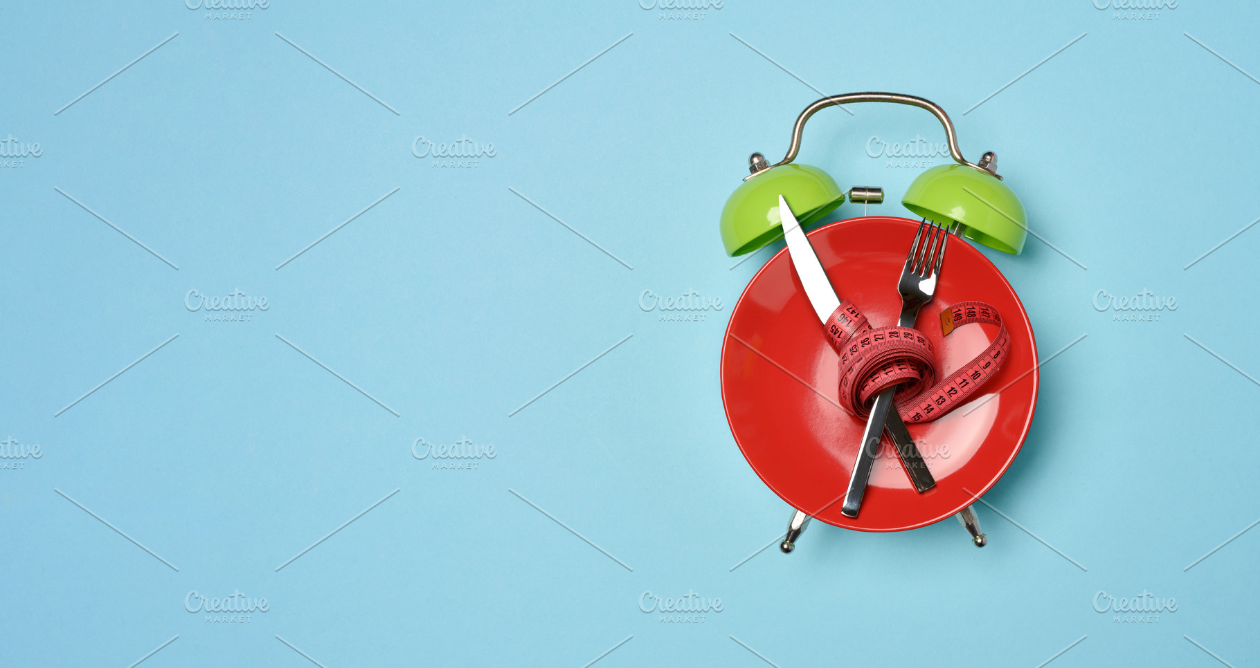 Diet concept image, red plate with crossed cutlery wrapped with, a Food & Drink Photo by ndanko