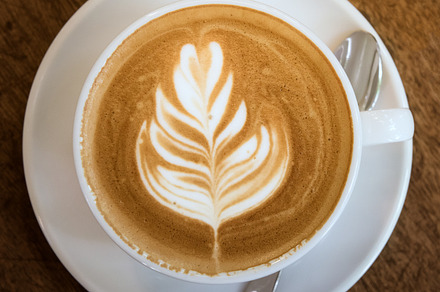 Cup of hot latte art coffee featuring cup, mocha, and cappucino