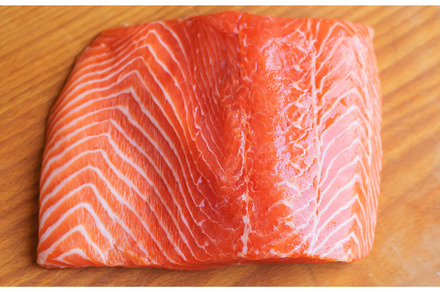 Red fish fillet cutting on the board, a Food & Drink Photo by yanadjana
