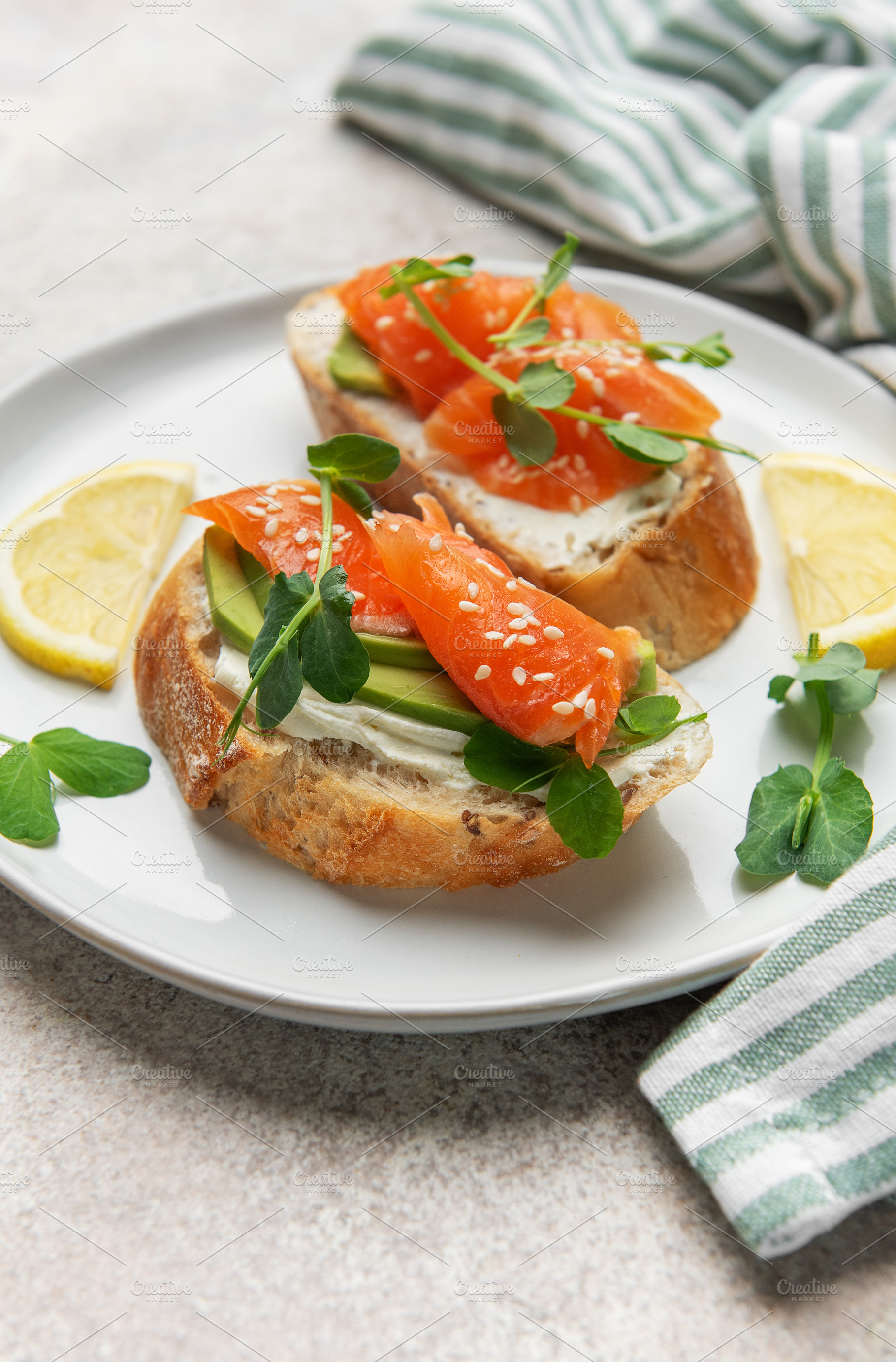 Salmon avocado toasts with cream cheese and microgreens, a Photo by Olena Rudo