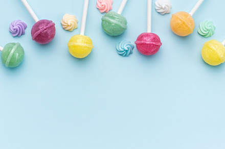 Sweet lollipops and candies on blue background, a Food & Drink Photo by Olena Rudo