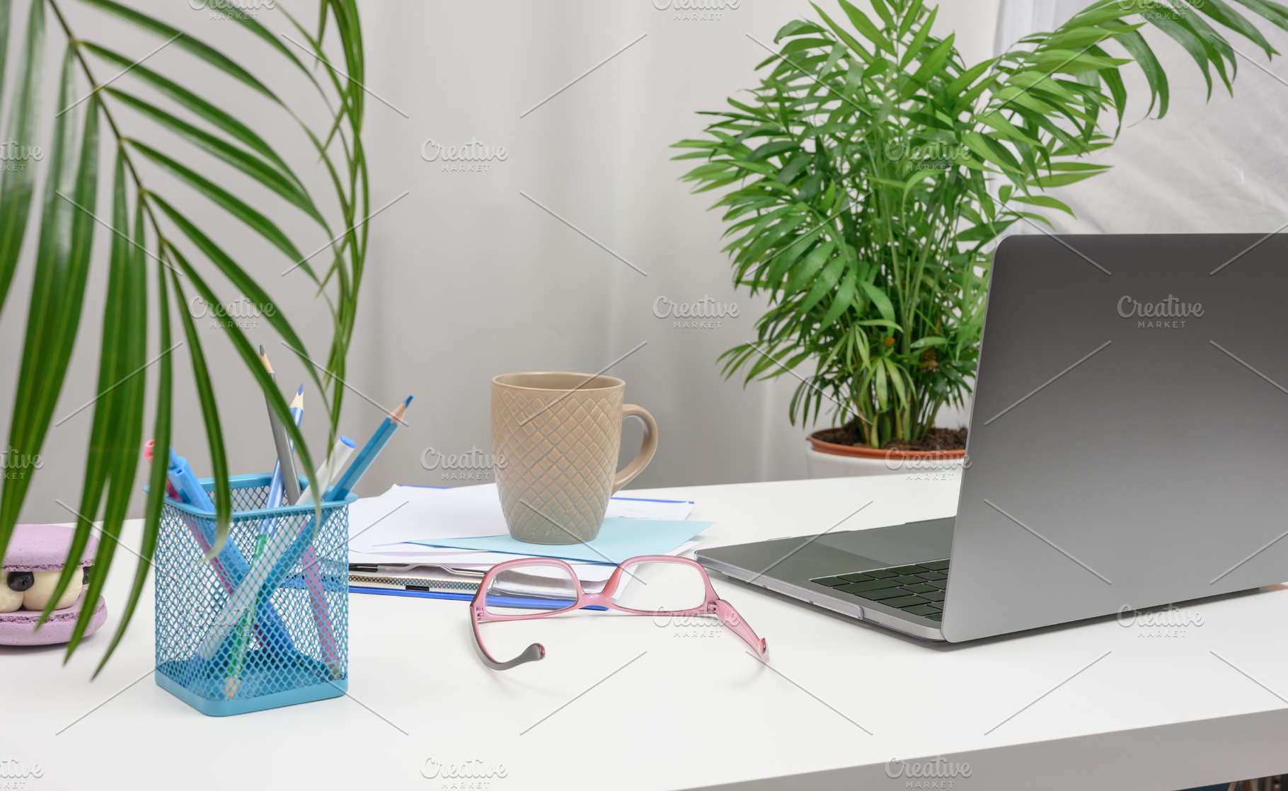 Modern workplace with open laptop, cup of coffee, pink glasses a, a Technology Photo by ndanko