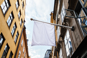 Commercial banner hanging from a building facade. Mockup