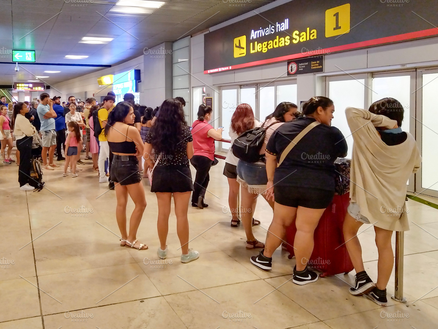 People queue at airport boarding gate under bright lights, a Person Photo by DanFLCreativo