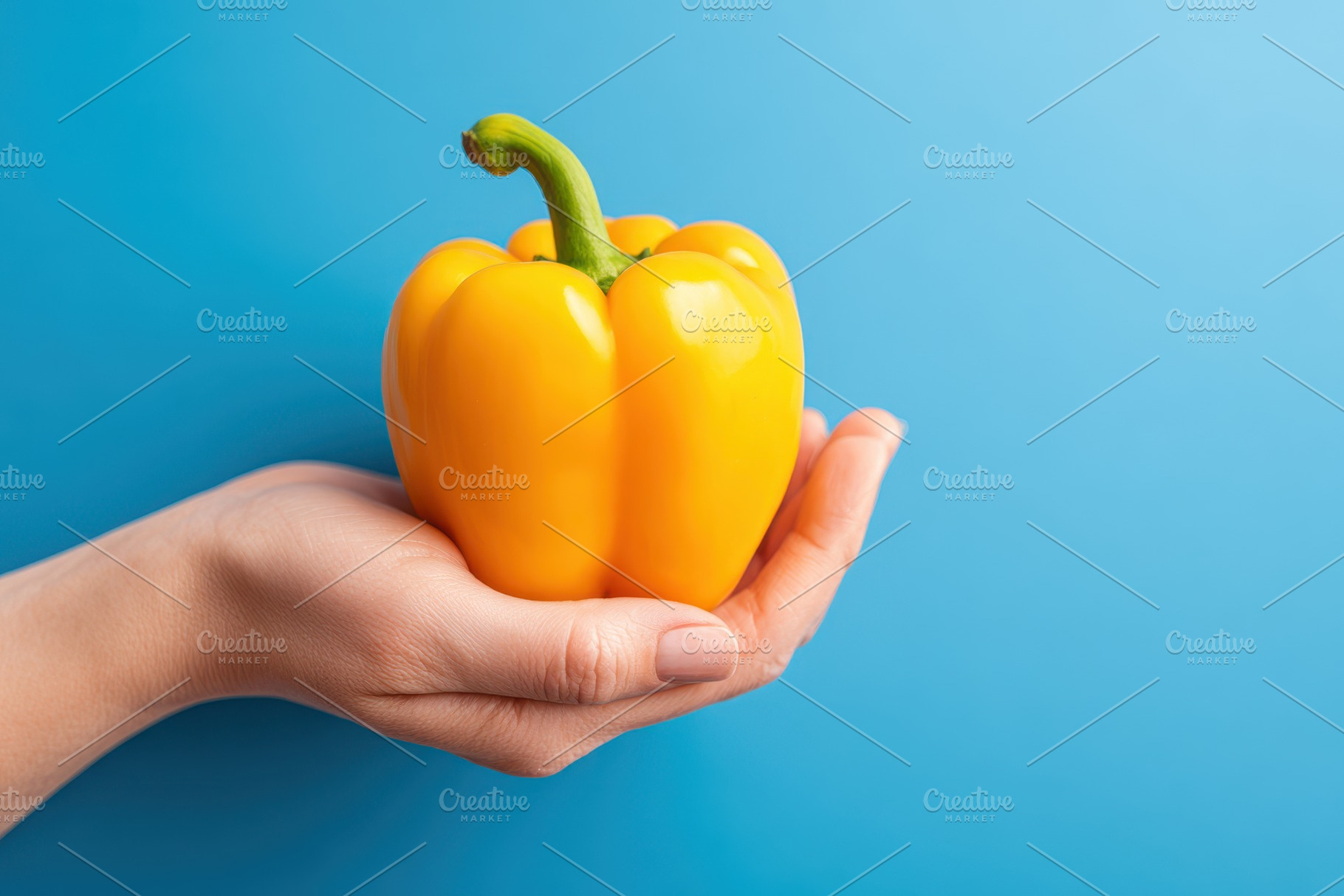 Hand holding a yellow bell pepper, a Food & Drink Photo by AlyaAnd