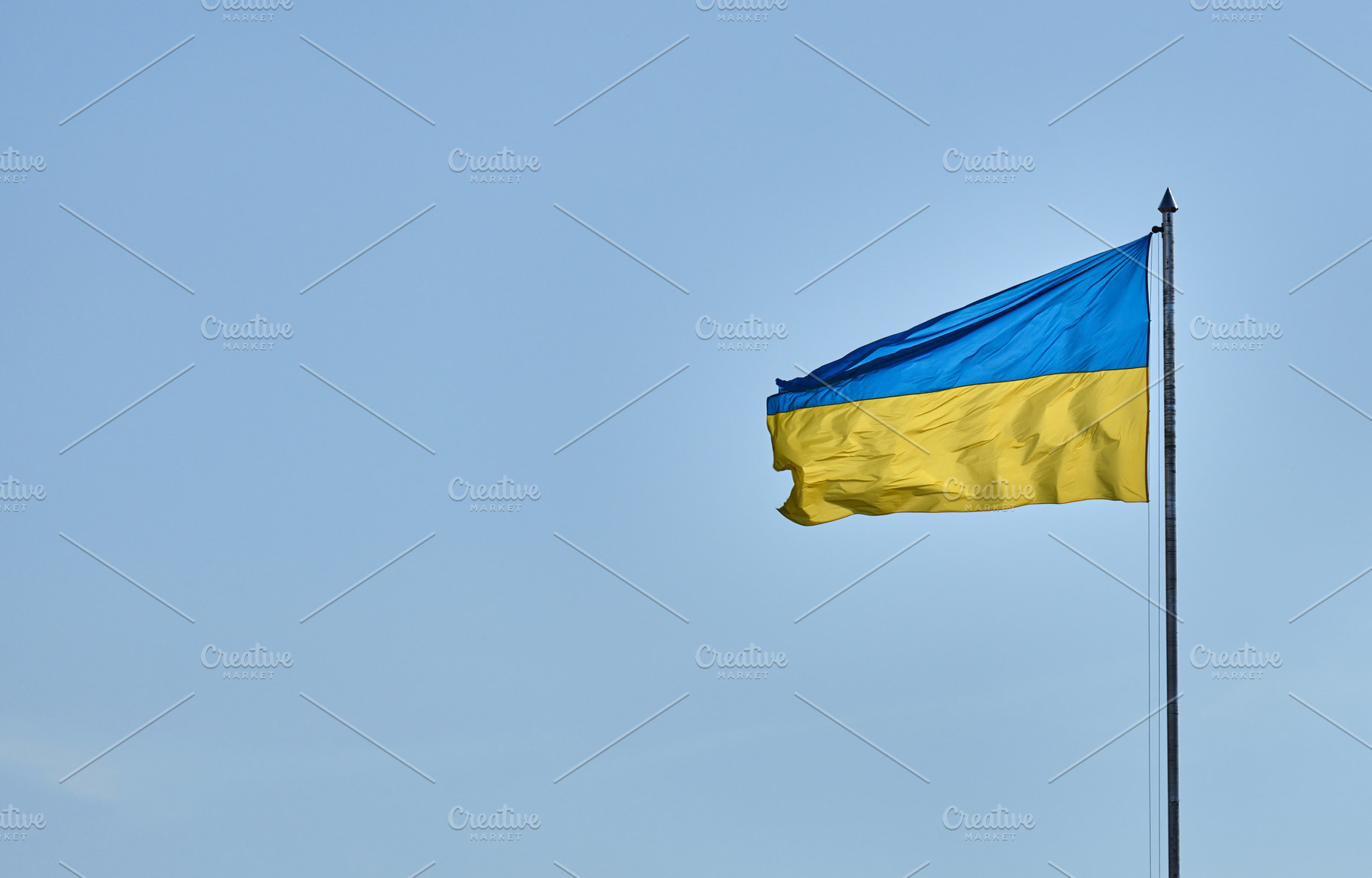 The Ukrainian flag on a high flagpole, the blue and yellow banne, a Background Photo by ndanko