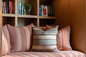 Cozy reading nook in a modern home, featuring comfortable stripe, a Photo by Studio ANNA