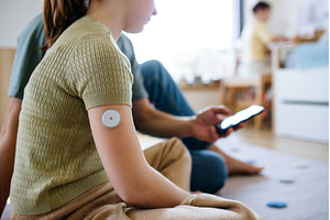 Diabetic girl with a CGM sensor on, a Health & Medical Photo by HalfPoint