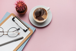 Coffee break accessories arranging on pink table with cactus pla, a Business Photo by Olena Rudo