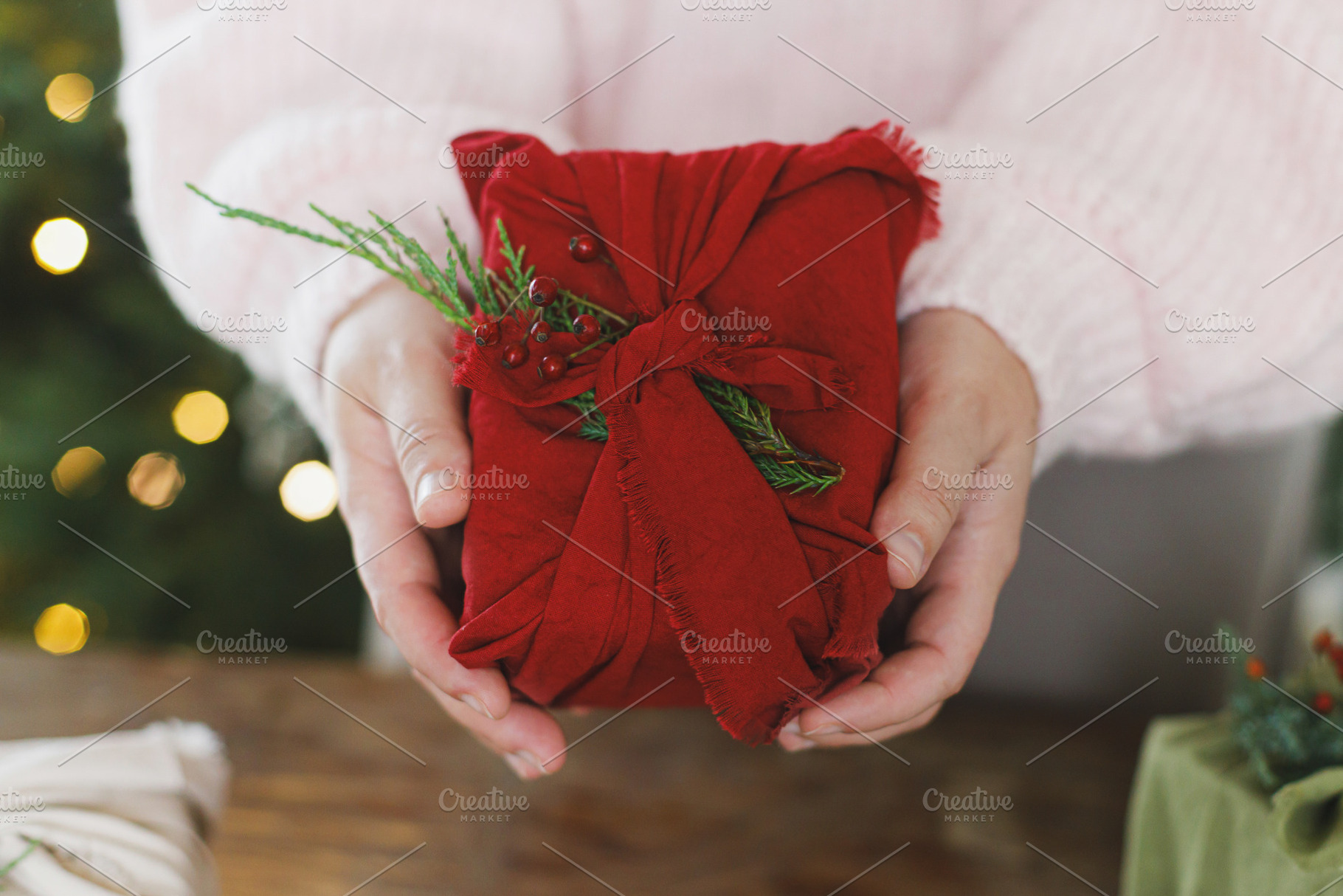 Zero waste christmas gift. Woman holding christmas present in re, a Holiday Photo by Sonjachni