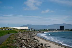 Seaside view in Akranes, Iceland with mountains and blue sky, a Photo by AS photostudio