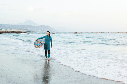 Surfer girl walking with board on the sandy beach. Surfer female.Beautiful youn, a Person Photo by Budarinphoto