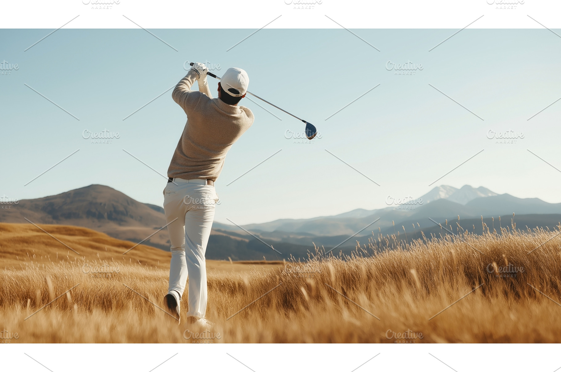 A golfer swings his club on a scenic, a Sports & Recreation Photo by Sergey Kotenev