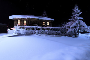 Old wooden house with a light in the
