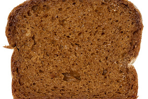 Piece of rye bread on a white isolated background, close up, a Food & Drink Photo by ndanko