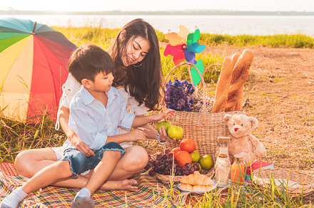 Beautiful Asian mother and son doing picnic and in Easter summer, a Person Photo by Ministocker
