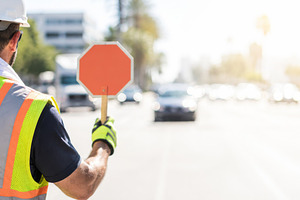 Construction worker holding stop sig, a Photo by Dvoevnore photos