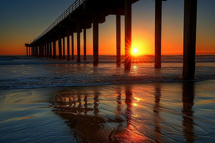 A stunning sunset bathes the sky in, a Photo by Tanuart