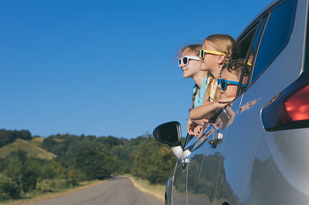 Happy kids sitting in the car containing car, child, and family