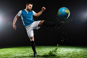 Soccer player kicking globe symbolizing World Cup competition, a Sports & Recreation Photo by Davizro's Market