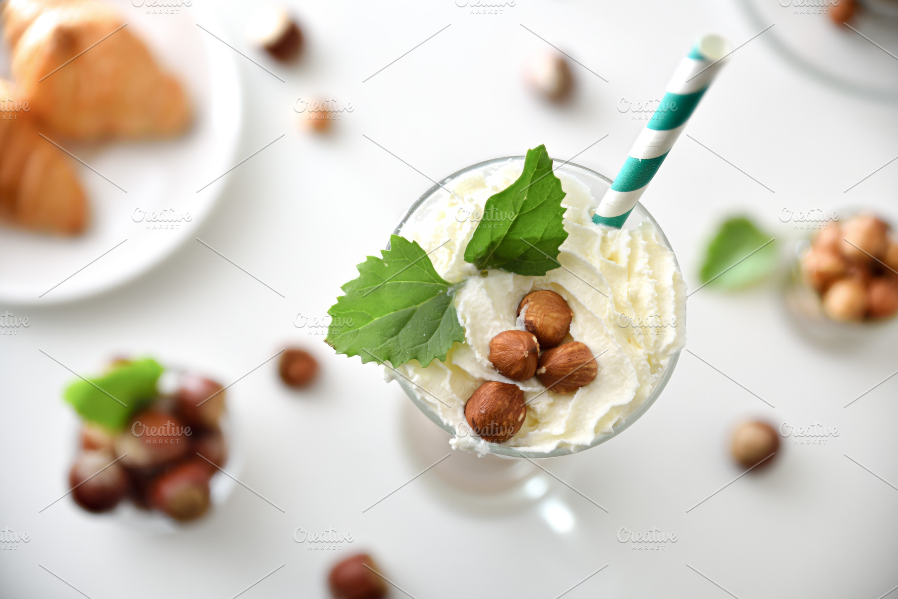 Detail of glass with hazelnut milkshake with cream and straw, a Food & Drink Photo by Davizro's Market