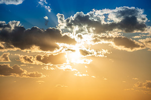 Sunset sky with clouds and sun