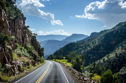 A road meanders through a mountainou, a Photo by Tanuart