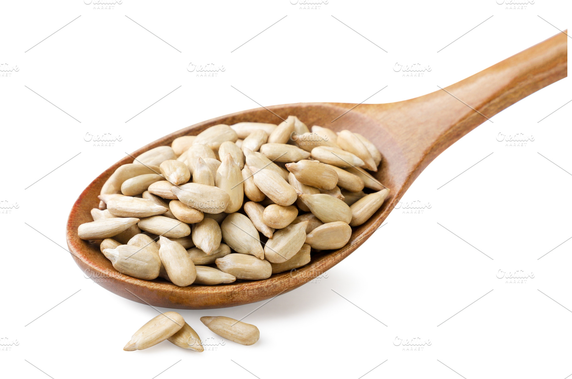 Sunflower kernels in a wooden spoon, a Food & Drink Photo by innakreativ