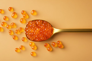Golden fish eggs on a spoon, a Photo by Beautiful things