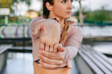 Sportswoman stretching hands and wrists outdoors, a Sports & Recreation Photo by davidpereiras