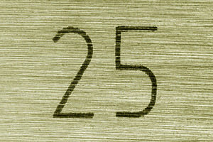 Scratched golden numbers 25 or twenty five on a piece metallic p, a Background Photo by Eugene_Photo