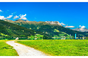 Road at lake reschen in italian alps containing italy, reschensee, and travel, a Nature Photo by Leonid Andronov