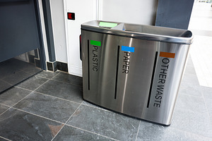 Modern recycling bins for plastic, paper, and waste in public location, a Photo by AS photostudio
