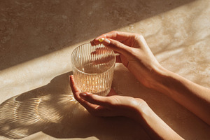 Hands holding a glass of drink, a Photo by Beautiful things