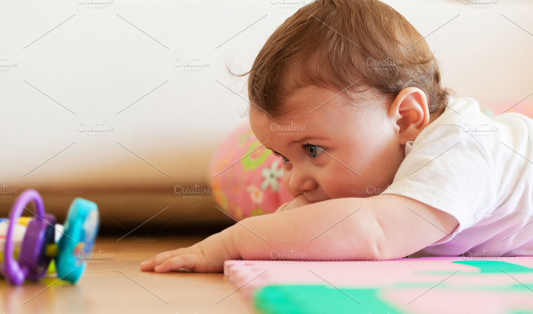 Toddler plays on the floor., a Person Photo by Antonio Gravante Market