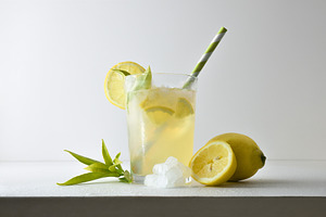 Refreshing lemon drink with ice on a white isolated background, a Food & Drink Photo by Davizro's Market