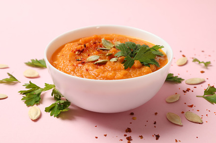 Composition with bowl of pumpkin soup on pink background, close, a Food & Drink Photo by AtlasStudio PRO