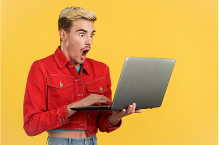 Stylish surprised gay man using a, a Person Photo by Iván Moreno STOCK PHOTO