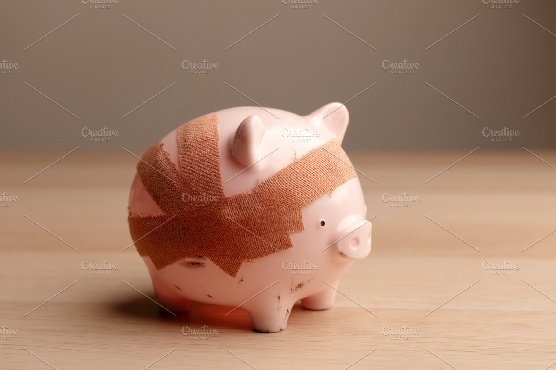 Damaged piggy bank with bandage, Fragile economy and financial c, a Photo by salmon.black