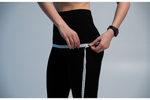 Woman measuring hips with a tape to, a Sports & Recreation Photo by volodymyrshtun13795